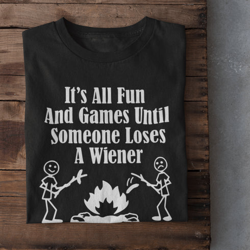 Our Camping tee features two adorable stick figure people roasting wieners over a cozy campfire. And with the hilarious slogan "It's All Fun & Games Until Someone Loses A Wiener," you'll be the life of the party at any camping trip!